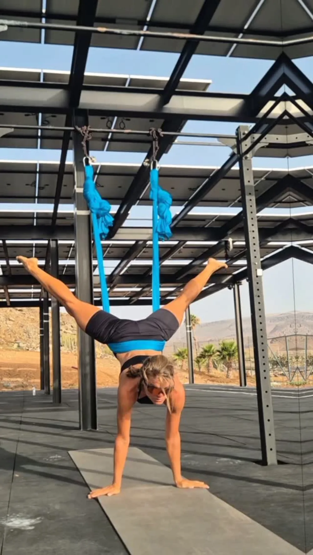 Emma in an aerial yoga pose under the solar roof at Monte Feliz, Gran Canaria