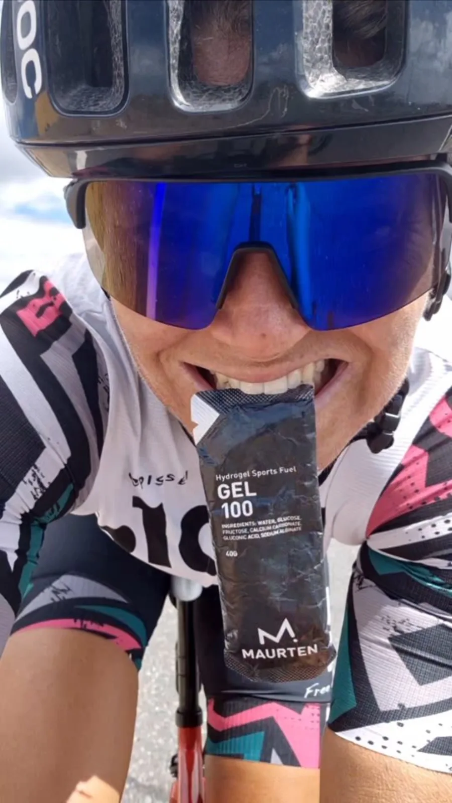 Emma grinning with a Maurten gel between her teeth