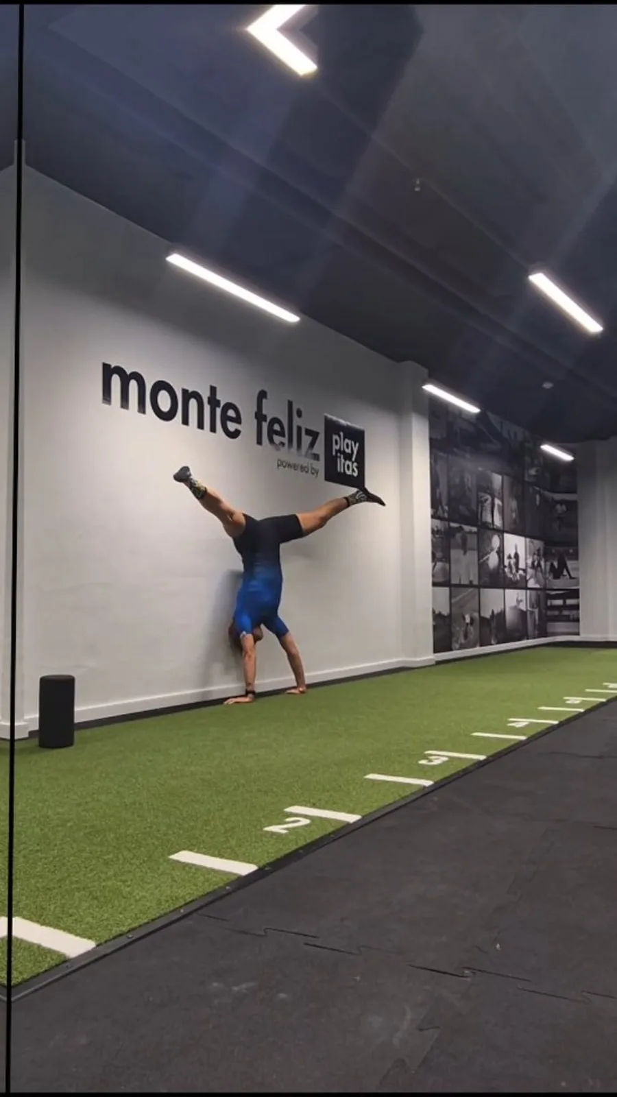 Emma doing a handstand against the wall in the Monte Feliz gym