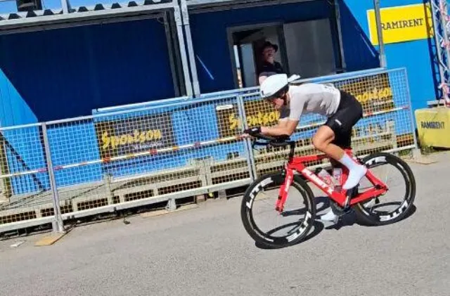 Emma racing the time trial on a red TT bike